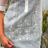 Closer look at waist and hip part of hand embroidered cocoon Bianca Barong Tagalog with Bianca's right forearm and hand shown with leaves in background