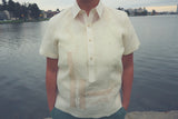 Product shot of the embroidered jusi Irma Barong Tagalog. Lake Merritt, trees and homes are in the background.
