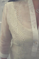 Closeup shot of the right shoulder of the hand embroidered cocoon Jeri Barong Tagalog. You can see Jeri's right arm and heart pendant necklace.