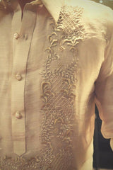 Closeup photo of the calado hand embroidery on the left shoulder of the Mansour Barong Tagalog. The pointed collar and center button placket can be seen also