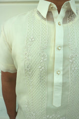 Closeup photo of the calado hand embroidery on the right side of the cocoon Marc Barong Tagalog. The collar and center button placket can be seen.