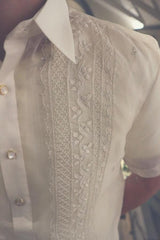 Closeup photo of the calado hand embroidery on the upper right corner of the cocoon Tiger Barong Tagalog. Tiger wears a chamisa de chino underneath his barong,