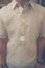 Product photo of the short sleeve hand embroidered cocoon Tiger Barong Tagalog. Tiger wears a chamisa de chino underneath his barong, a watch on his left wrist and a brown beaded bracelet on his right wrist
