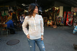 Amanda looking left in her custom long sleeve hand embroidered jusi Barong Tagalog and jeans at a market in Harlem, New York City