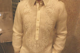 Product shot of the hand embroidered piña silk Blase Barong Tagalog with marble wall and vent behind him
