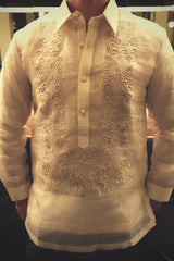 Product photo of the hand embroidered piña silk Mansour Barong Tagalog. Mansour wears a chamisa de chino underneath his barong. Mansour has his hands behind his back