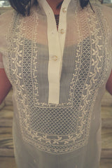 Closeup on the body of the hand embroidered cocoon Barong Tagalog. Natalia wears a black tank top underneath her barong.